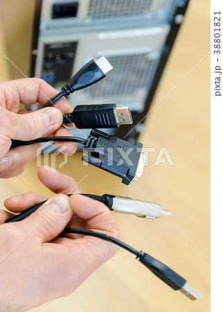The various cords and plugs in the hands. The various cords and plugs in the hands. 38801821