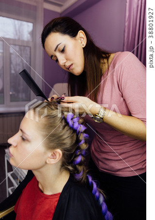 girl in the beauty salon is weaved with braids 38801927