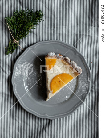 Piece of pie with persimmon on a plate 38802482
