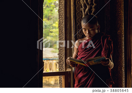 Closeup Buddhist novice reading at Shwenandaw pagoda, mandalay, myanmar Closeup Buddhist novice reading at Shwenandaw pagoda, mandalay, myanmar 38805645