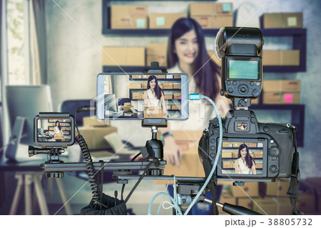 Professional set of camera with smart mobile phone and action camera on tripod over young asian teenager owner business woman work at home for online shopping, Live Streaming for entrepreneur concept Professional set of camera with smart mobile phone and action camera on tripod over young asian teenager owner business woman work at home for online shopping, Live Streaming for entrepreneur concept 38805732