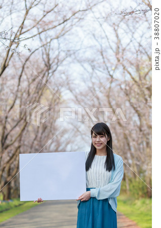 公園でメッセージボードを持つ若い女性　春 38807020