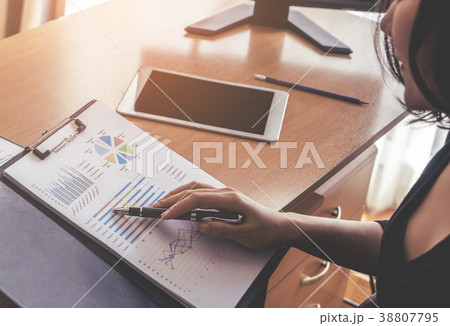 Female Sale Manager reading sales report in office Female Sale Manager reading sales report in office 38807795