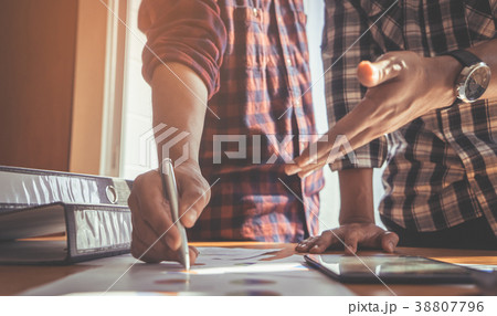 Pen and person hand discussing on business report Pen and person hand discussing on business report 38807796