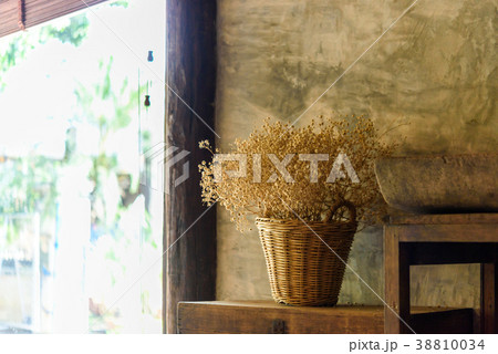 dry flower in basket beside the wall 38810034