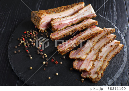 speck cut in slices on black slate 38811190