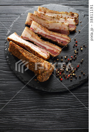 piced smoked speck cut in slices 38811191