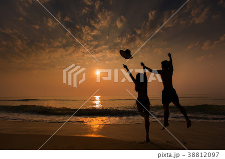 Couple jump and feel happy. On the beach Couple jump and feel happy. On the beach 38812097