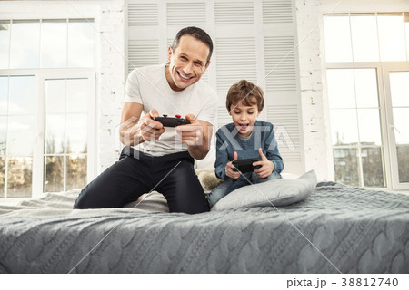 Cheerful dad and son playing games 38812740
