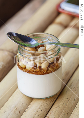 Glass jar with delicious yogurt Glass jar with delicious yogurt 38820339