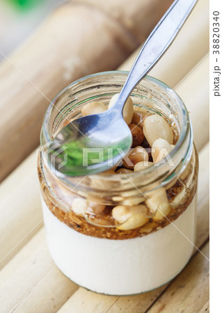 Glass jar with delicious yogurt 38820340