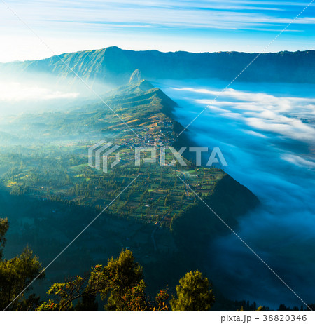 Village on highland with fog during sunrise 38820346