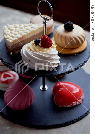 Cakes on a dark slate bunk stand.Desserts. Sweet 38820695