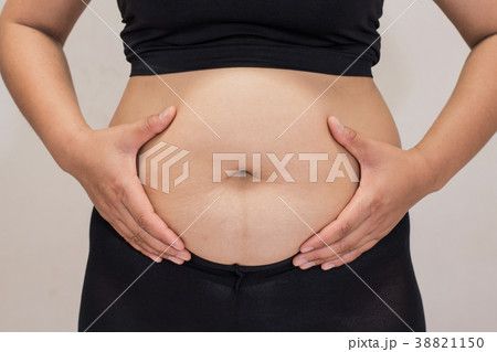 women body fat belly front view and hand squeezing 38821150