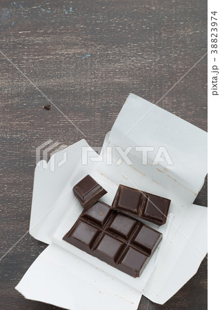 Open carton box with dark chocolate bar 38823974