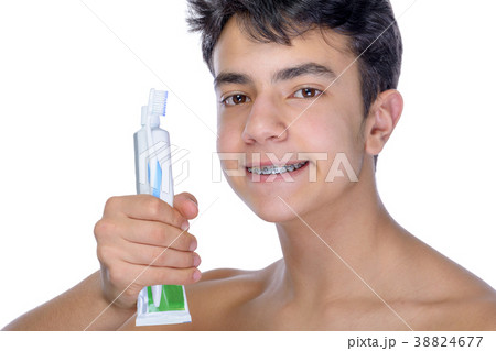 Teen boy wearing braces on white background 38824677