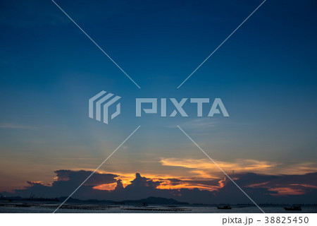 Nice sun ray in twilight sky at sea with island 38825450