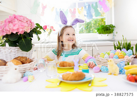 Kids at Easter breakfast. Eggs basket, bunny ears. Kids at Easter breakfast. Eggs basket, bunny ears. 38827575