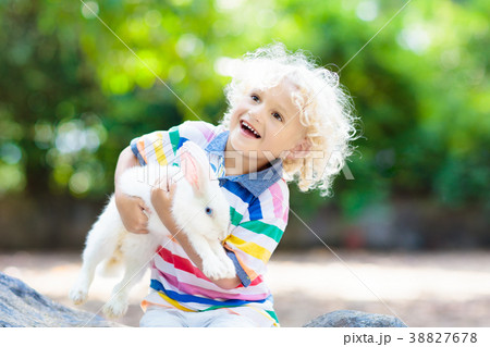 Child with rabbit. Easter bunny. Kids and pets. 38827678