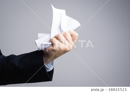 Business man hand crunching a paper in anger 38835523