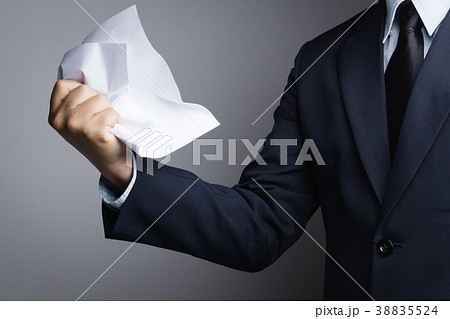 Business man hand crunching a paper in anger 38835524