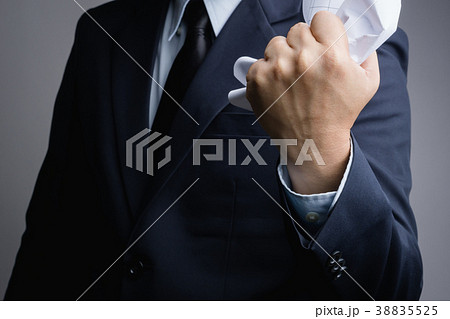 Business man hand crunching a paper in anger 38835525