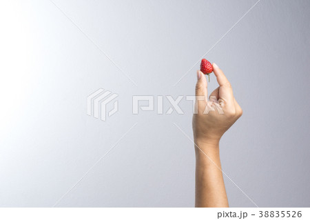 Hand holding fresh strawberry 38835526