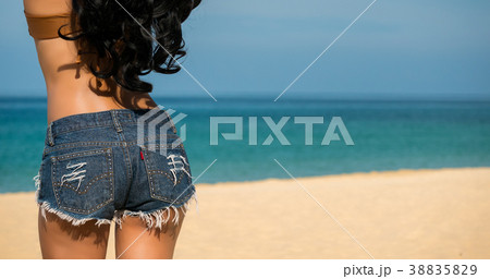 Close up sexy woman ass with jeans on the beach 38835829