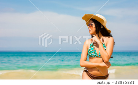 Asian woman on beach are posted to take a photo Asian woman on beach are posted to take a photo 38835831