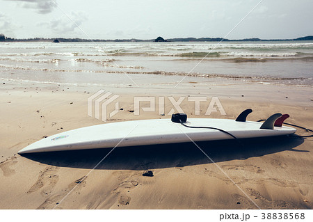 White Surfboard with leg leash on beach 38838568