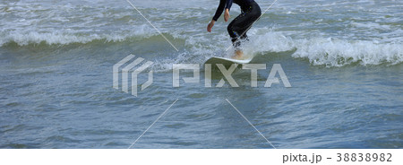 riding wave on surf board in ocean 38838982