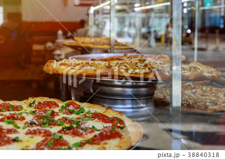 pizza on a wooden counter of Large slice of pizza 38840318