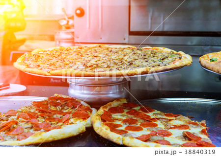Deluxe Pizza with a slice of pizza 38840319
