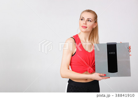 woman holding scales in hands woman holding scales in hands 38841910