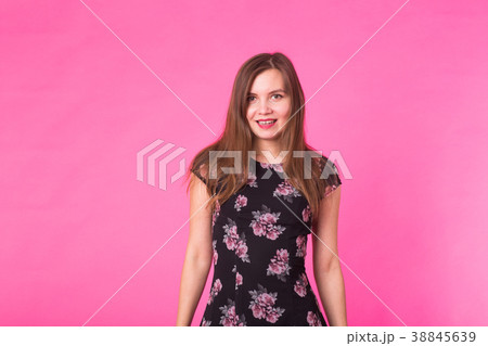 Young woman in a dress on a pink background 38845639