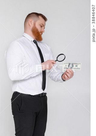 expert looking at magnifying glass for bill expert looking at magnifying glass for bill 38846407