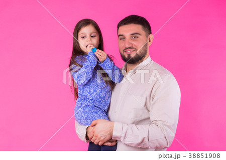 Happy father holding baby daughter in hands over Happy father holding baby daughter in hands over 38851908