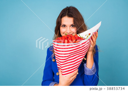 Young woman holding bouquet of strawberries on Young woman holding bouquet of strawberries on 38853734