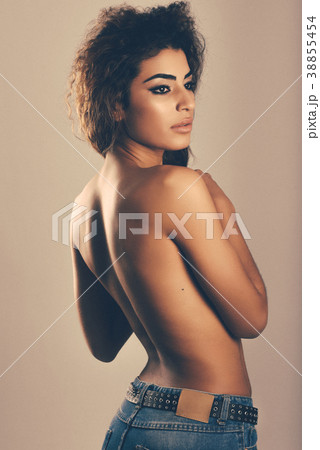 Young woman with beautiful back wearing blue jeans Young woman with beautiful back wearing blue jeans 38855454