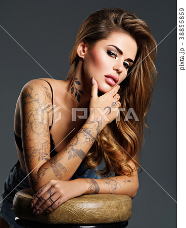 Beautiful sexy girl with a tattoo on the body - Stock Photo [38856869] -  PIXTA