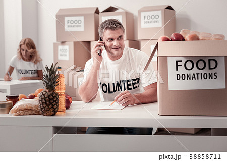 Enigmatical grey-haired man looking at box 38858711