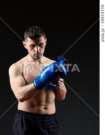 Low key studio portrait of handsome muscular 38859158