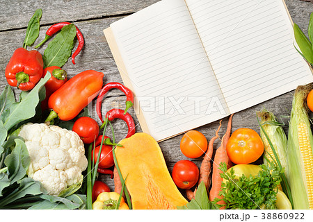 Open recipe book with set of raw organic 38860922