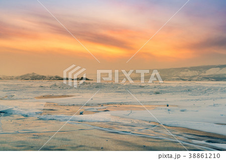 Winter frozen water lake with sunset sky Winter frozen water lake with sunset sky 38861210