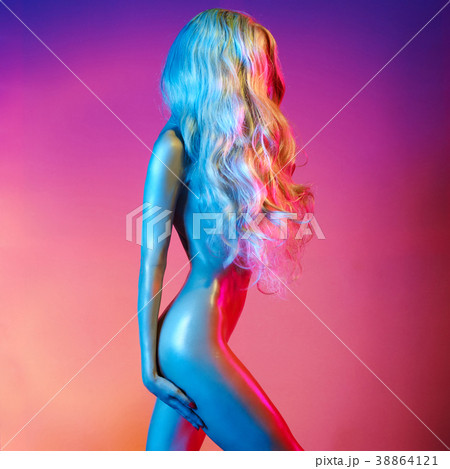 Nude sexy blonde in colorful light. 38864121