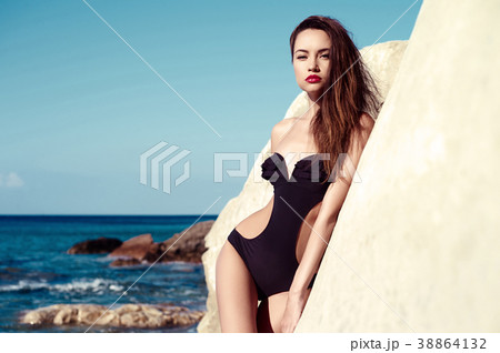 Beautiful slender brunette at the sea Beautiful slender brunette at the sea 38864132