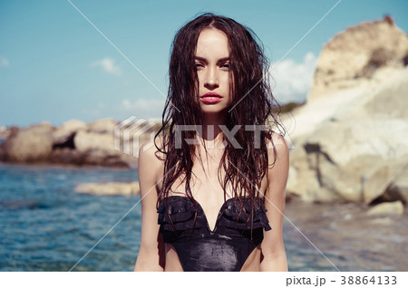 Beautiful slender brunette at the sea Beautiful slender brunette at the sea 38864133