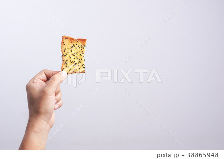 Hand holding butter rusk bread loaf with black sesame Hand holding butter rusk bread loaf with black sesame 38865948