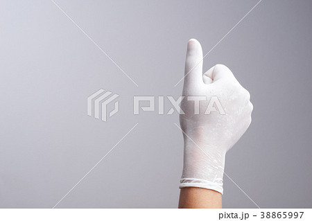 Hand wearing latex glove with thumb up gesture 38865997