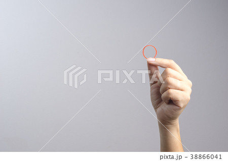 Hand holding elastic rubber band Hand holding elastic rubber band 38866041